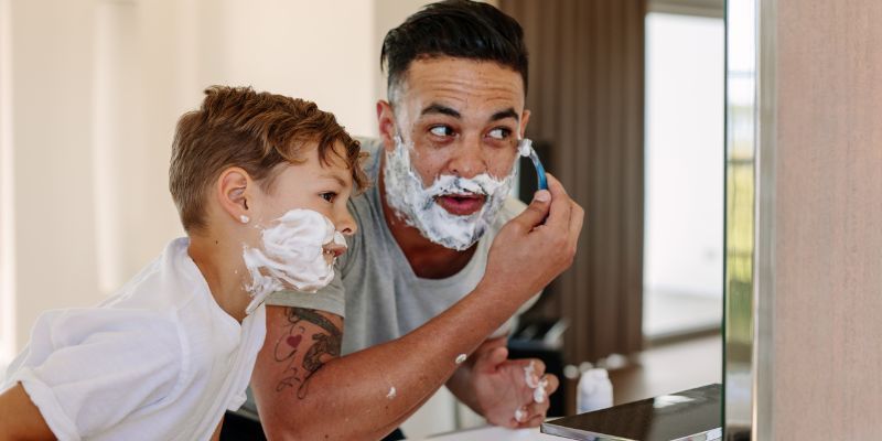 Father shaving with son